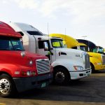 yellow semi-truck parked in the desert