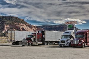 multiple semi-trucks parked at gas station